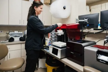 Photo of the dental assistant attending to a task.
